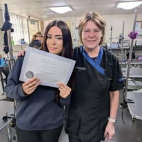 Student receiving her platinum certificate on her dog grooming course Banbury