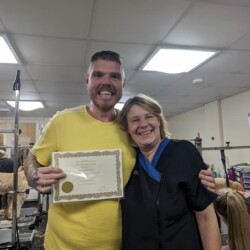 Student receiving a certificate at a dog grooming course in Evesham
